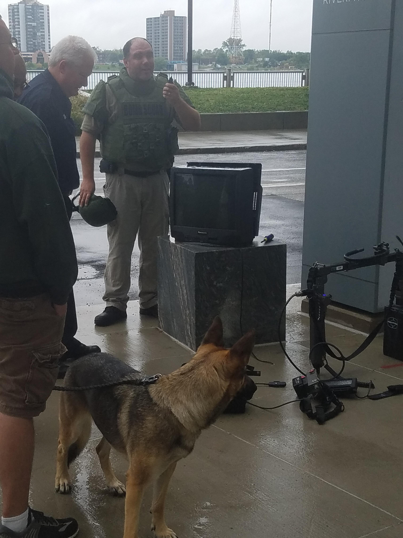 A member of the Detroit Police Department bomb squad checks out an abandoned CRT at Cobo Center, via Reddit